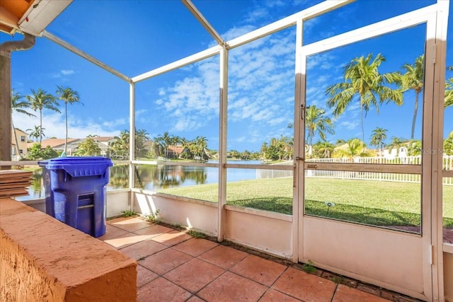 unfurnished sunroom with a water view