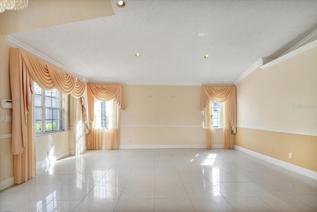 empty room featuring crown molding, a textured ceiling, and a wealth of natural light