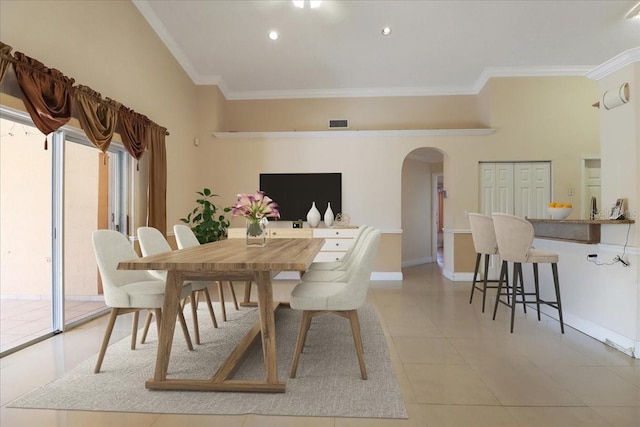 dining area with light tile patterned floors and crown molding