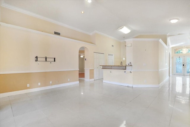 tiled spare room with crown molding and high vaulted ceiling