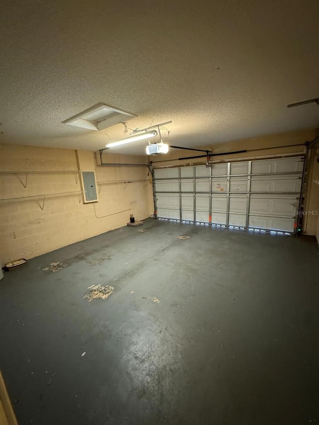 garage with a garage door opener and electric panel