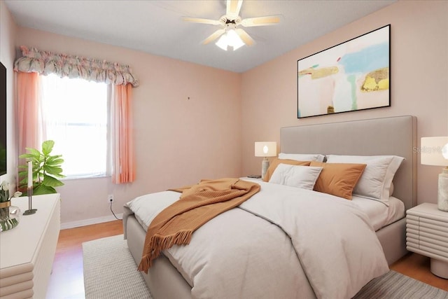 bedroom with hardwood / wood-style flooring and ceiling fan