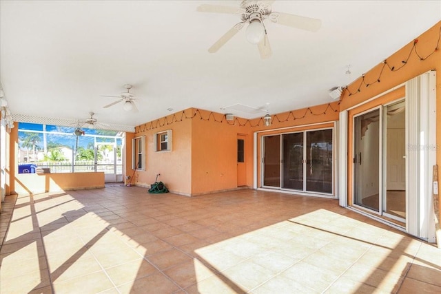 unfurnished sunroom featuring ceiling fan