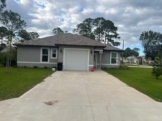 view of front of property featuring a garage and a front lawn