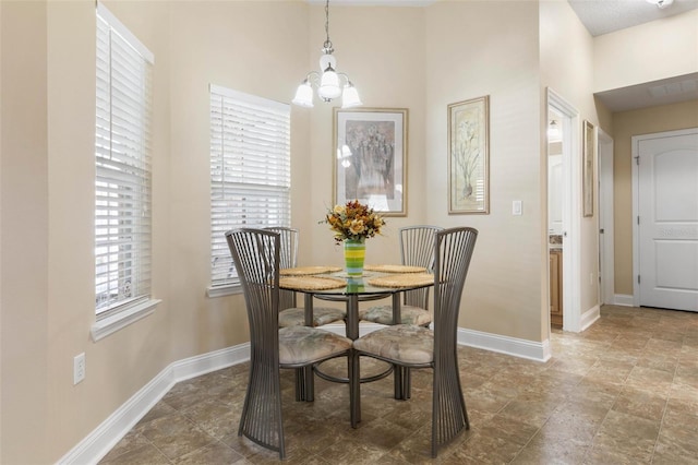 dining space with an inviting chandelier, visible vents, and baseboards