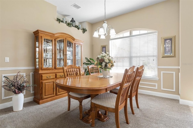 dining space with visible vents, a chandelier, a wealth of natural light, and light colored carpet