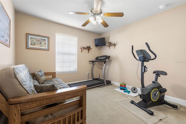 workout room with light carpet, ceiling fan, and baseboards