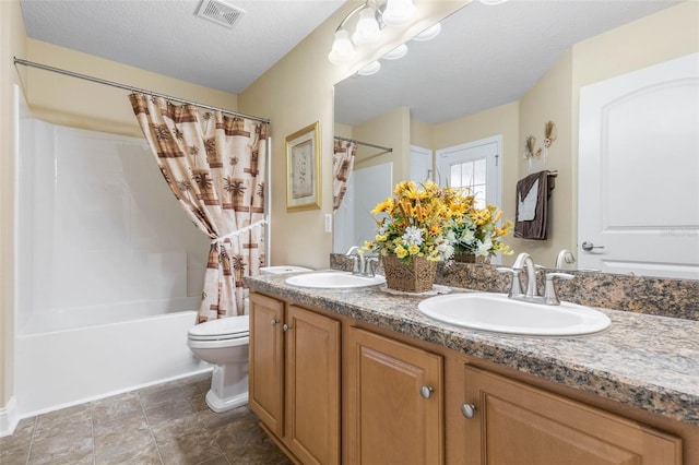 bathroom featuring double vanity, a sink, visible vents, and shower / tub combo with curtain