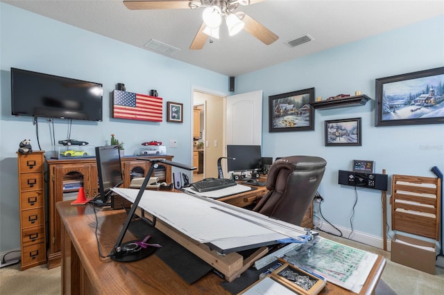 office with light carpet, ceiling fan, visible vents, and baseboards