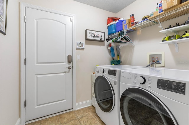 clothes washing area featuring laundry area, a textured ceiling, baseboards, and washer and dryer