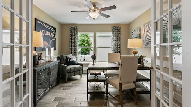 sitting room with ceiling fan and french doors