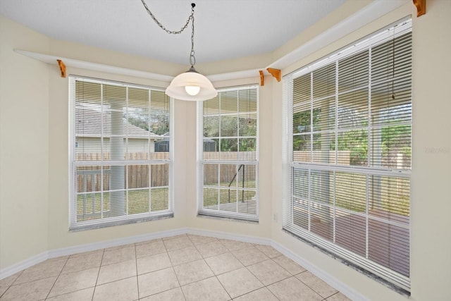 unfurnished dining area featuring light tile patterned floors