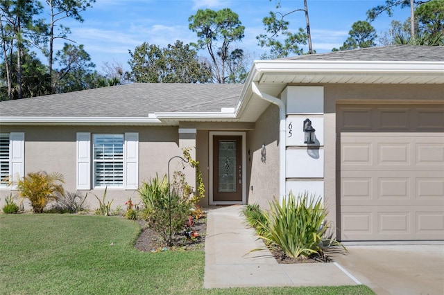 doorway to property featuring a yard and a garage