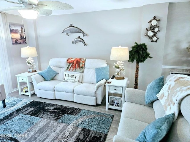 living room featuring ceiling fan and hardwood / wood-style floors