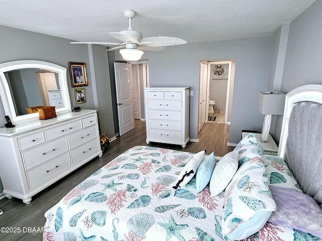 bedroom featuring dark wood-type flooring, connected bathroom, and ceiling fan