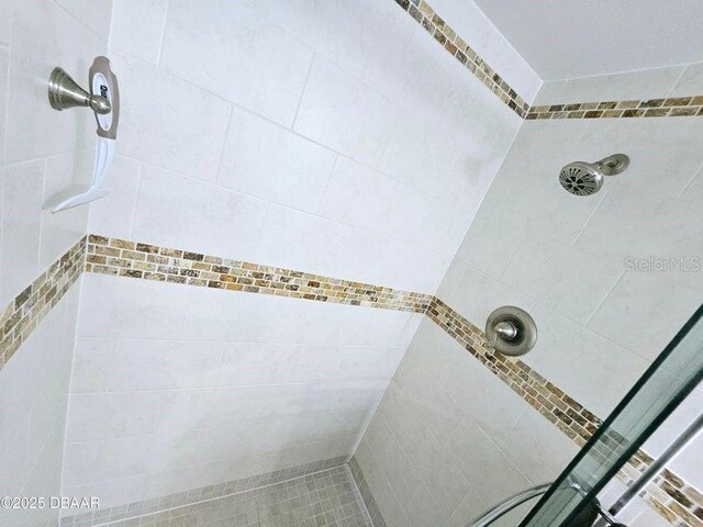 bathroom with tiled shower