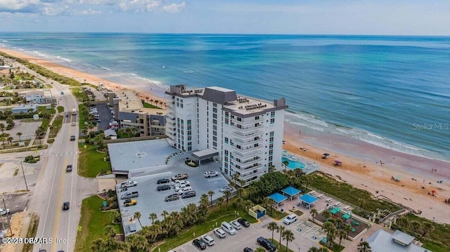 bird's eye view with a water view and a beach view