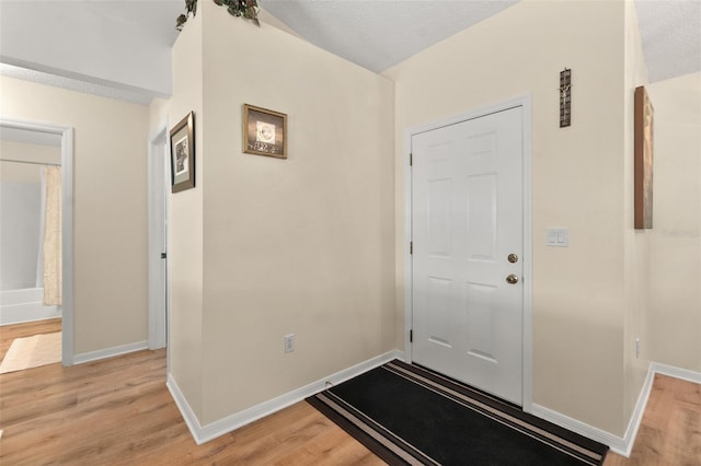 foyer featuring light hardwood / wood-style flooring and a textured ceiling