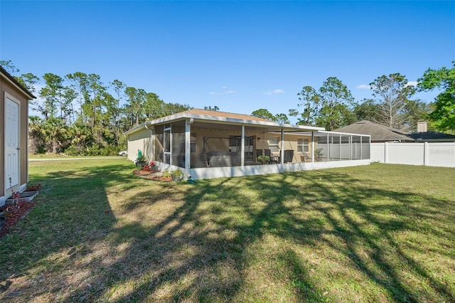 back of property featuring a yard and a sunroom