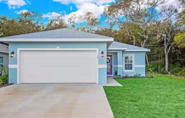 view of front of property featuring a garage and a front lawn