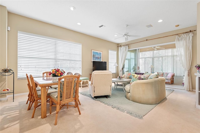 carpeted living room featuring ceiling fan