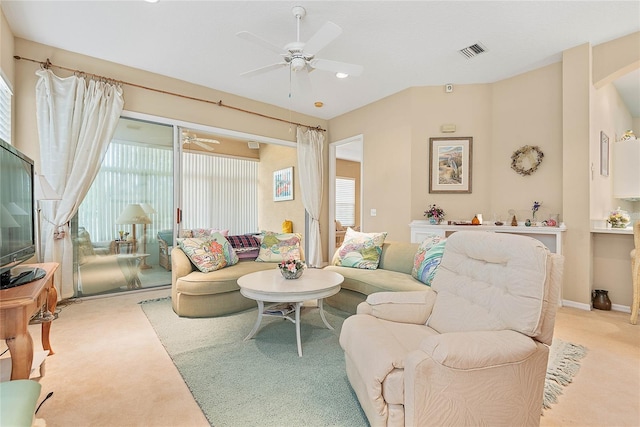 carpeted living room featuring ceiling fan and plenty of natural light