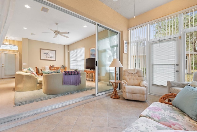 living room featuring ceiling fan and light tile patterned floors