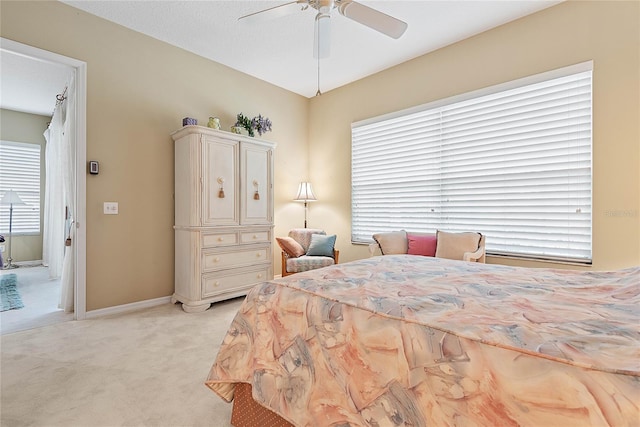 bedroom with ceiling fan and light colored carpet