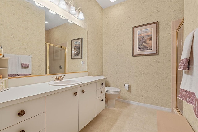 bathroom with vanity, toilet, and walk in shower