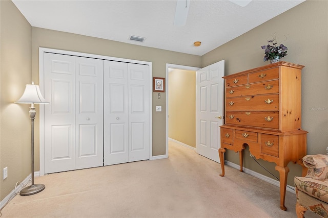 carpeted bedroom with a closet and ceiling fan