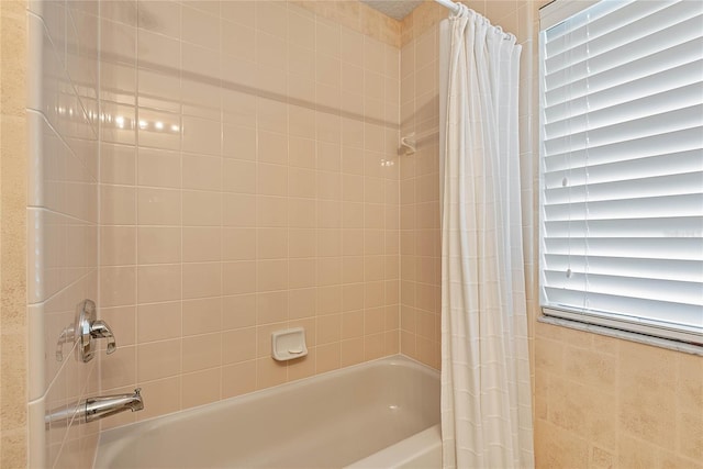 bathroom with shower / bathtub combination with curtain