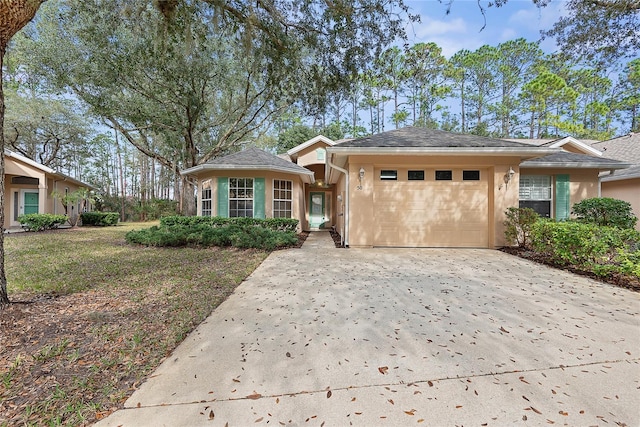 view of front of house with a garage and a front yard