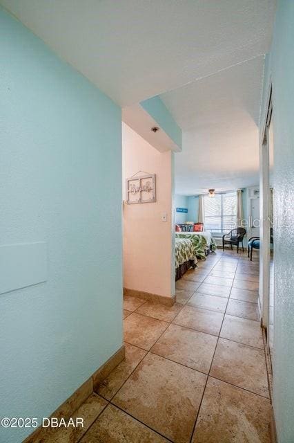 corridor featuring light tile patterned floors