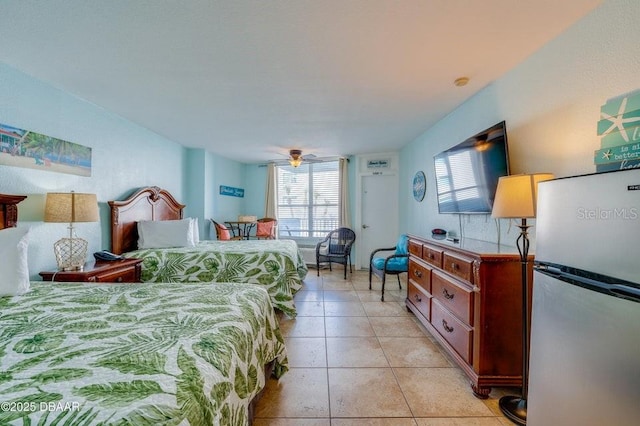 bedroom featuring stainless steel fridge and light tile patterned floors