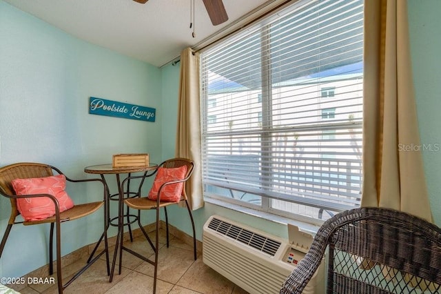 sitting room with light tile patterned floors and ceiling fan