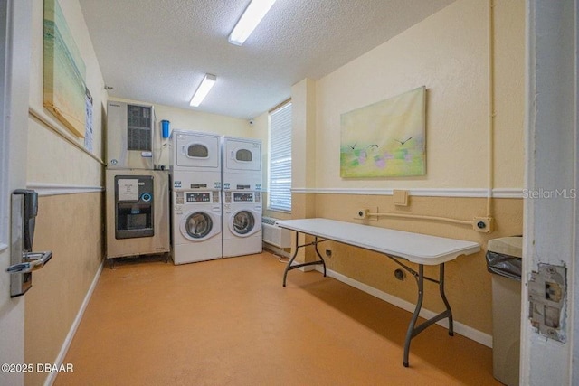 washroom with stacked washer and dryer and a textured ceiling