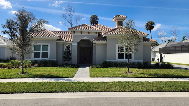 mediterranean / spanish-style home with a front yard