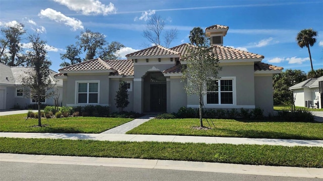 mediterranean / spanish-style home with a front yard