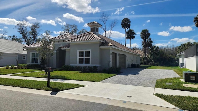 view of front of property with a garage and a front lawn