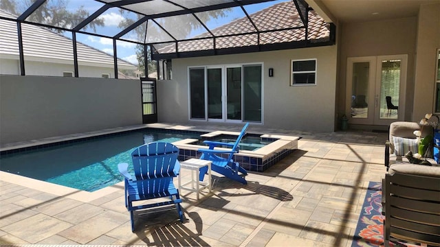 view of swimming pool featuring a lanai, a patio area, french doors, and an in ground hot tub