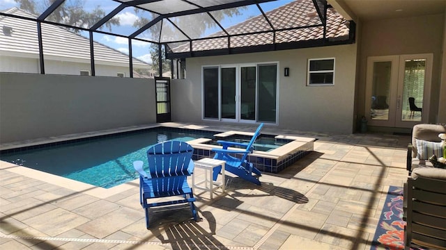 view of pool with an in ground hot tub, a patio area, and french doors