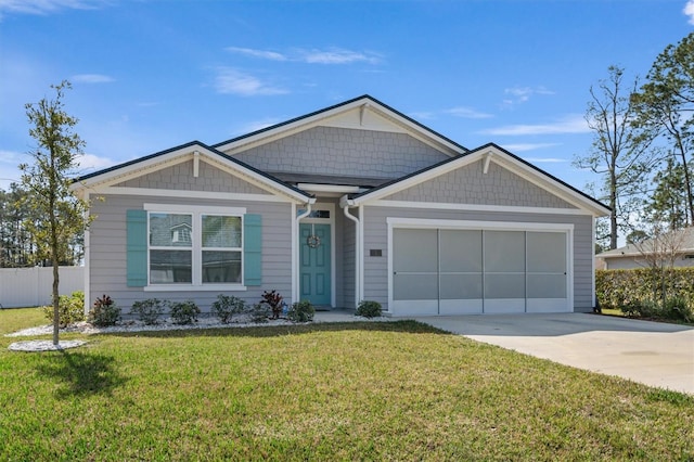 view of front of house with a garage and a front lawn