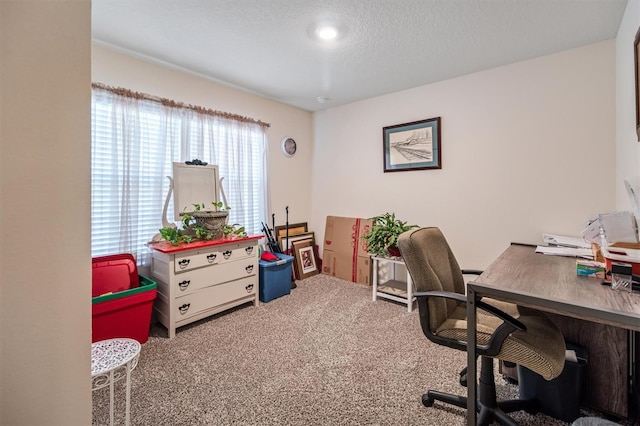 home office featuring carpet floors and a textured ceiling