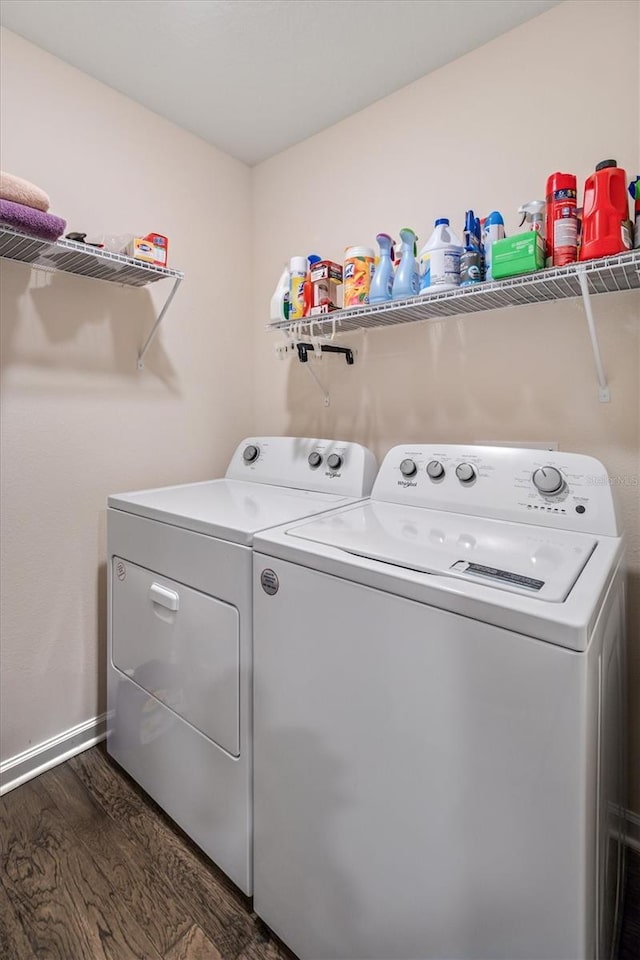 laundry room with dark hardwood / wood-style floors and washer and clothes dryer