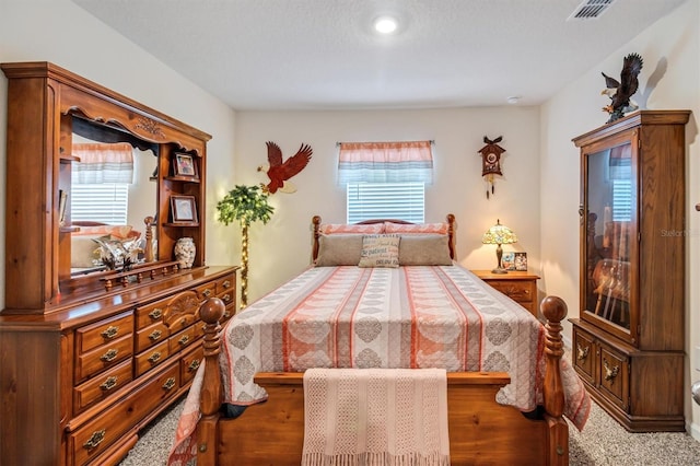 bedroom with multiple windows and carpet