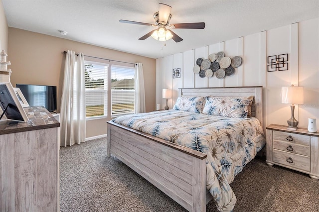 bedroom featuring ceiling fan and dark carpet