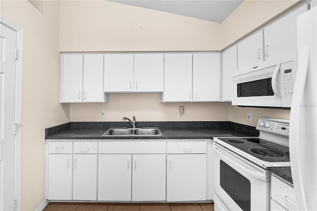 kitchen featuring white cabinetry, sink, and white appliances