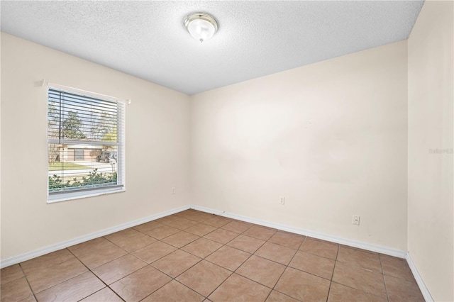 unfurnished room featuring a textured ceiling