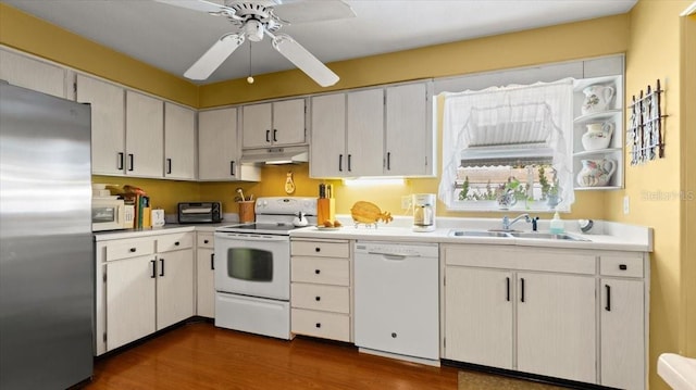 kitchen featuring dark wood-type flooring, sink, ceiling fan, white appliances, and white cabinets