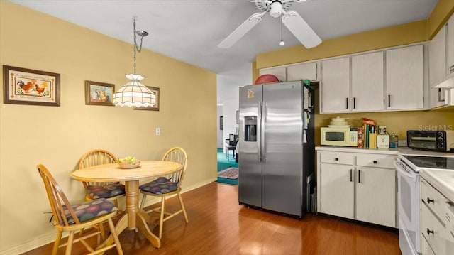 kitchen featuring hardwood / wood-style floors, decorative light fixtures, white cabinetry, ceiling fan, and white appliances